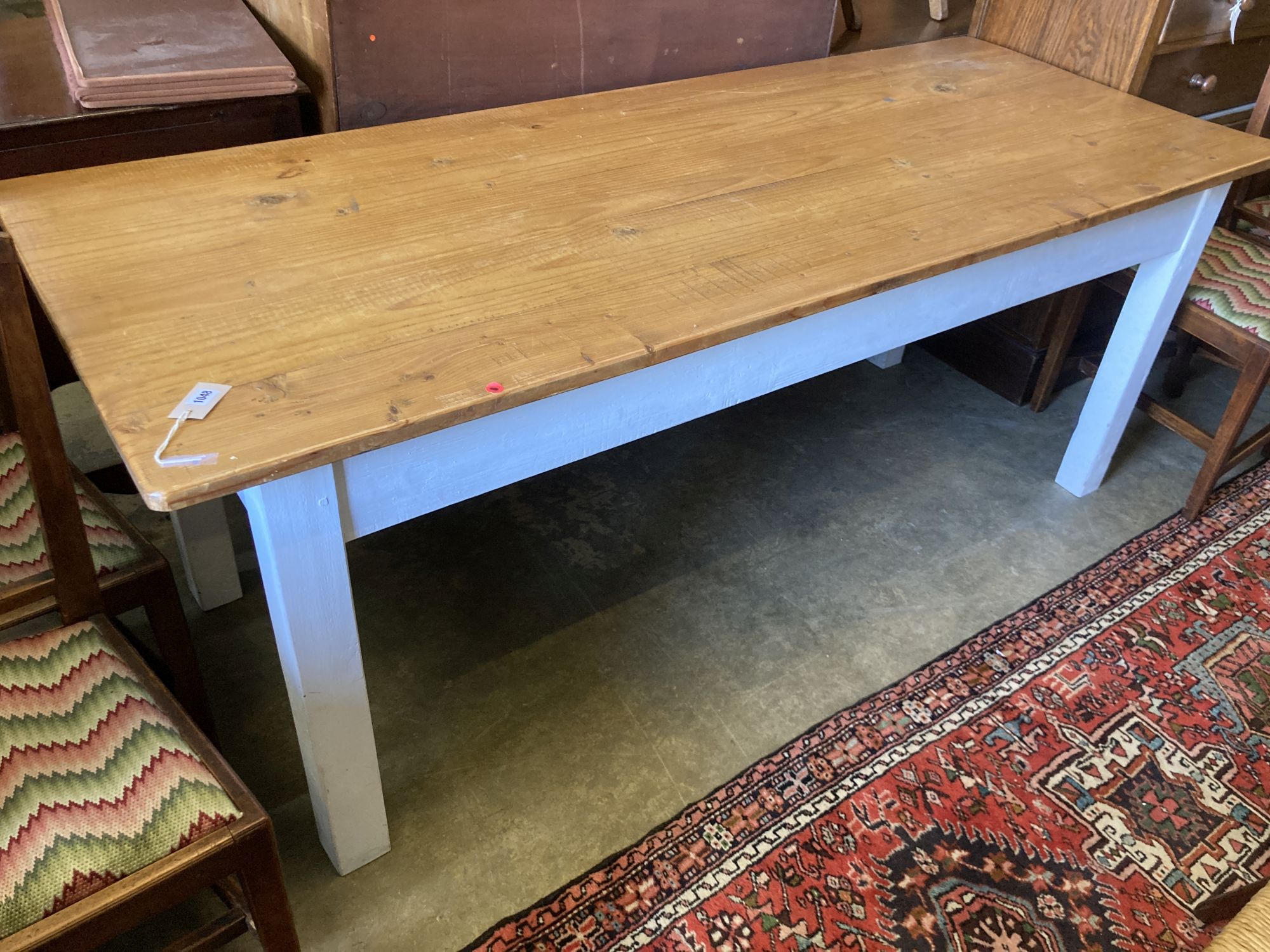 A rectangular pine kitchen table with painted underframe, length 198cm, depth 79cm, height 77cm